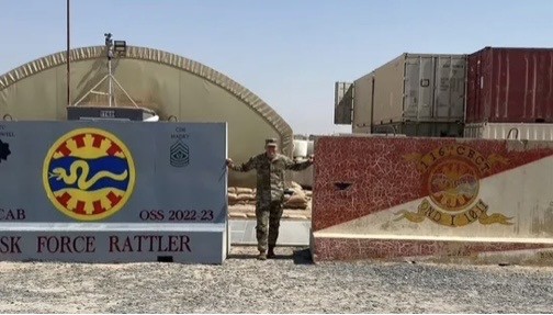 Deployment image near the Task Force Rattler sign