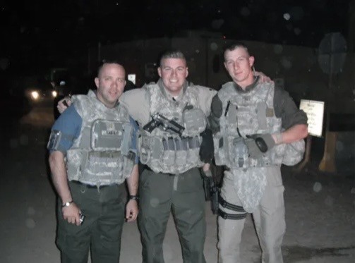 Nighttime operational photo with Nick Edwards and fellow servicemembers